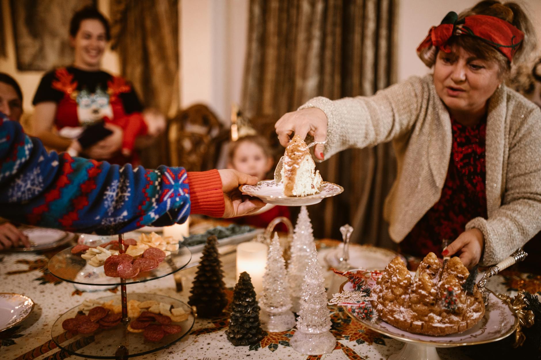 Festive family Christmas gathering with cake sharing, joyful holiday atmosphere.