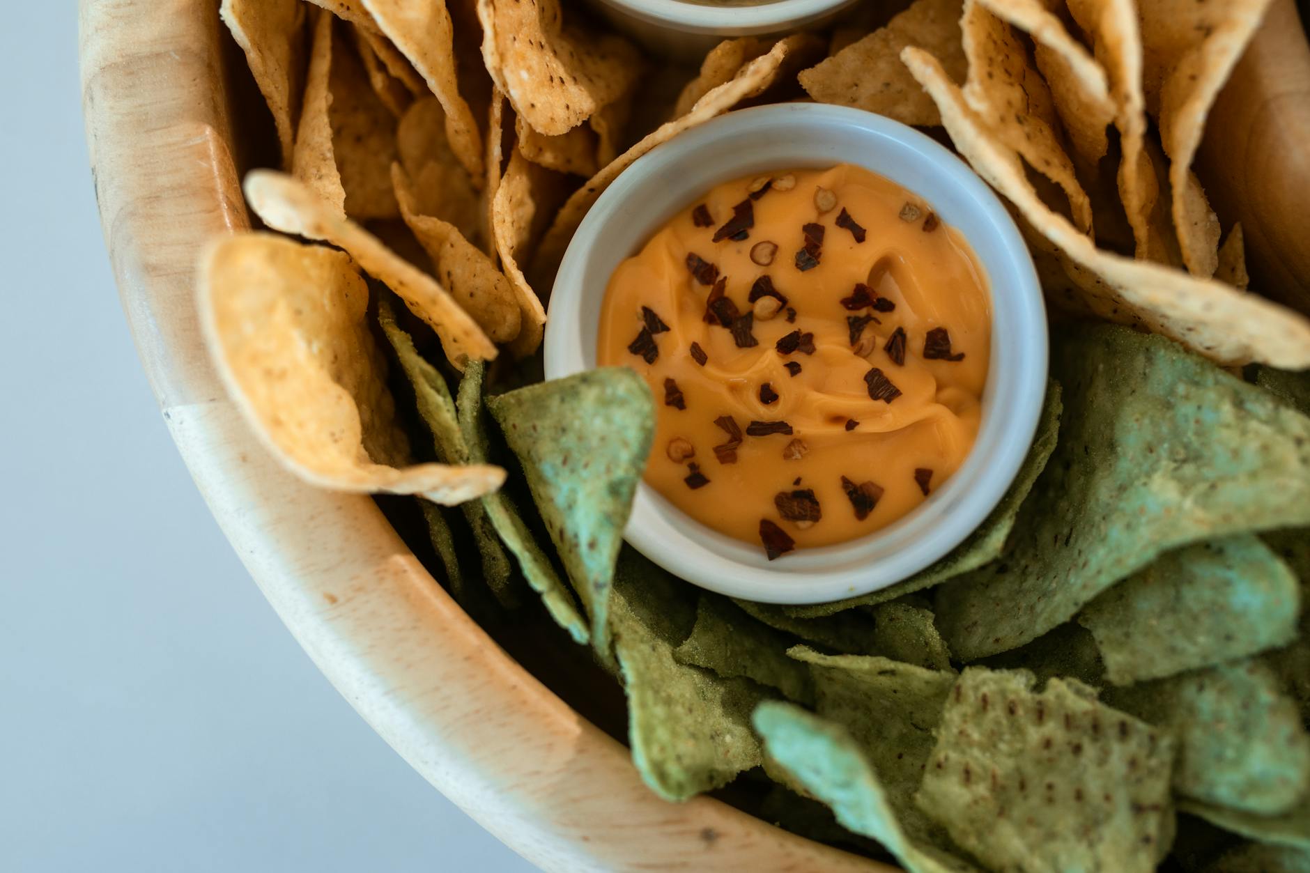 Top view of nacho chips with a spicy cheese dip perfect for snacking occasions.