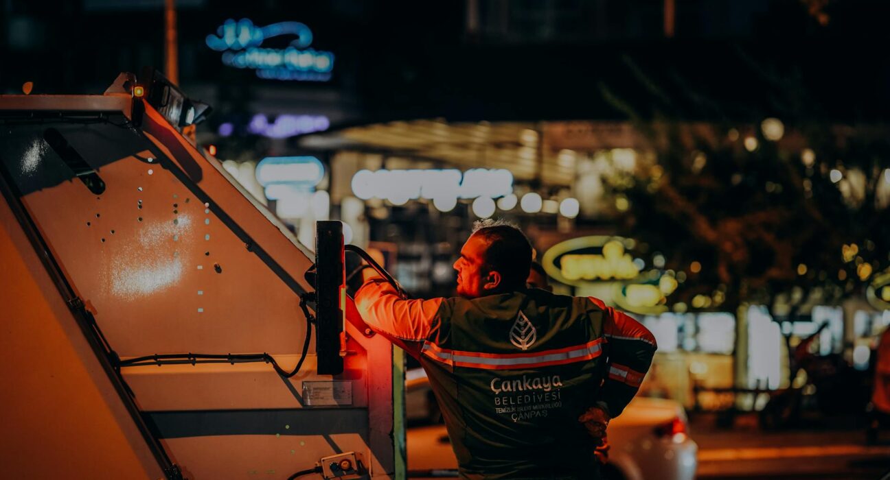 Sanitation worker in Ankara doing urban night work, enhancing city cleanliness.