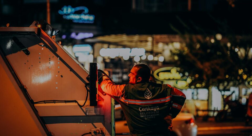 Sanitation worker in Ankara doing urban night work, enhancing city cleanliness.