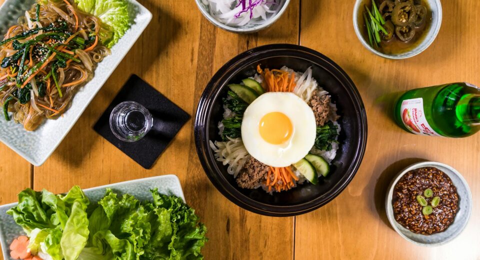 Delicious assortment of Korean dishes including bibimbap in a flatlay composition.