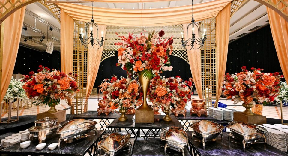 Elegant wedding venue with lavish floral decor and buffet setup in Bandung, Indonesia.