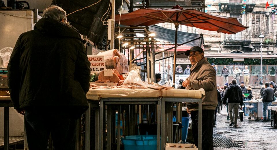 Explore the vibrant atmosphere of a bustling fish market in Catania, Sicily, showcasing local vendors and fresh produce.