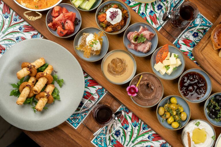 Colorful Turkish meze platter with diverse dishes on a wooden table, offering a rich culinary experience.