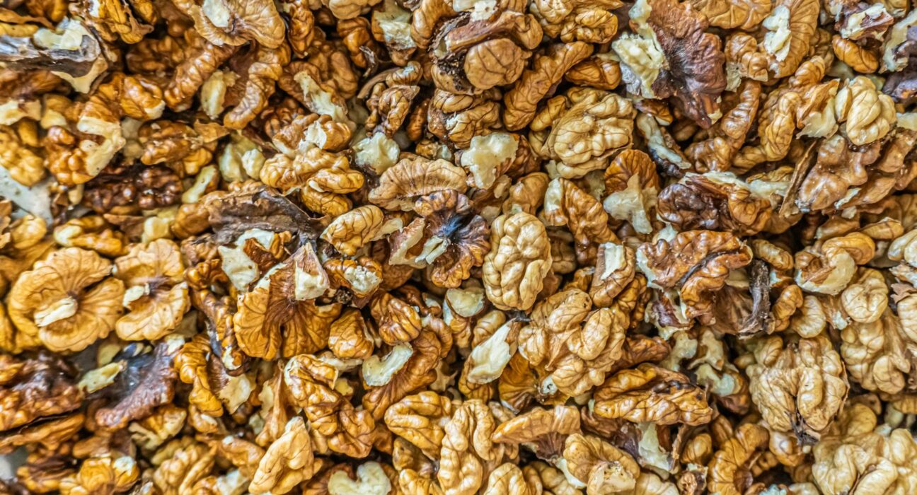 Top view of numerous shelled walnuts clustered together, ideal for culinary and health-related content.