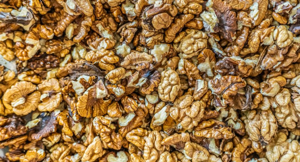 Top view of numerous shelled walnuts clustered together, ideal for culinary and health-related content.