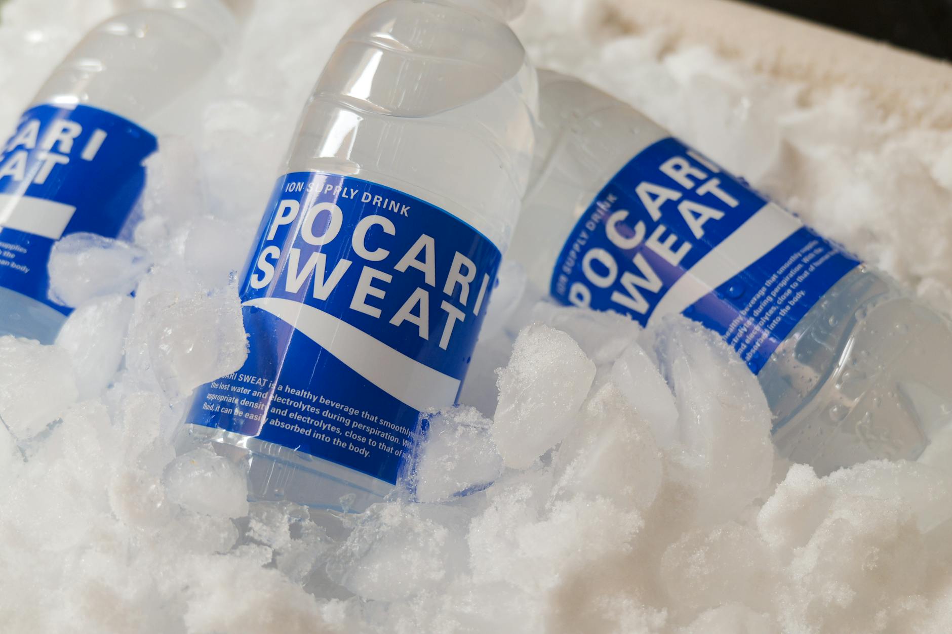 Refreshing Pocari Sweat bottles embedded in ice, showcasing hydration and cooling.
