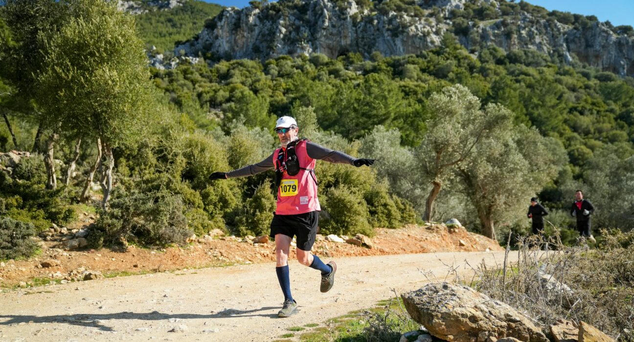 Energetic trail runner in scenic nature near İzmir, Türkiye, showcasing outdoor adventure.