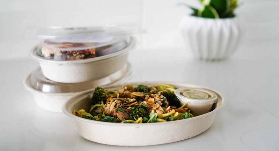A nutritious takeout meal featuring broccoli and seeds, neatly packaged for convenience.
